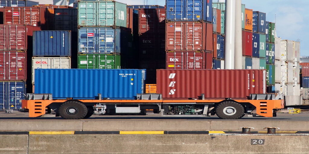 A photo showing an automated vehicle transporting two shipping containers in the Port of Rotterdam